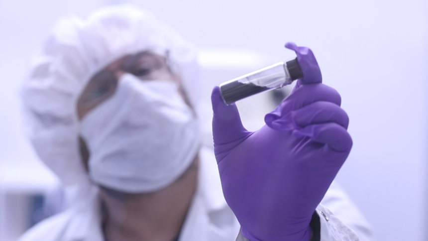 A vial that contains part of the sample from asteroid Bennu is held up by Jason Dworkin, the NASA's OSIRIS-REx mission's project scientist, in 2023.