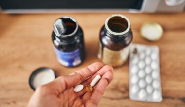 Pouring vitamins on one hand from a bottle