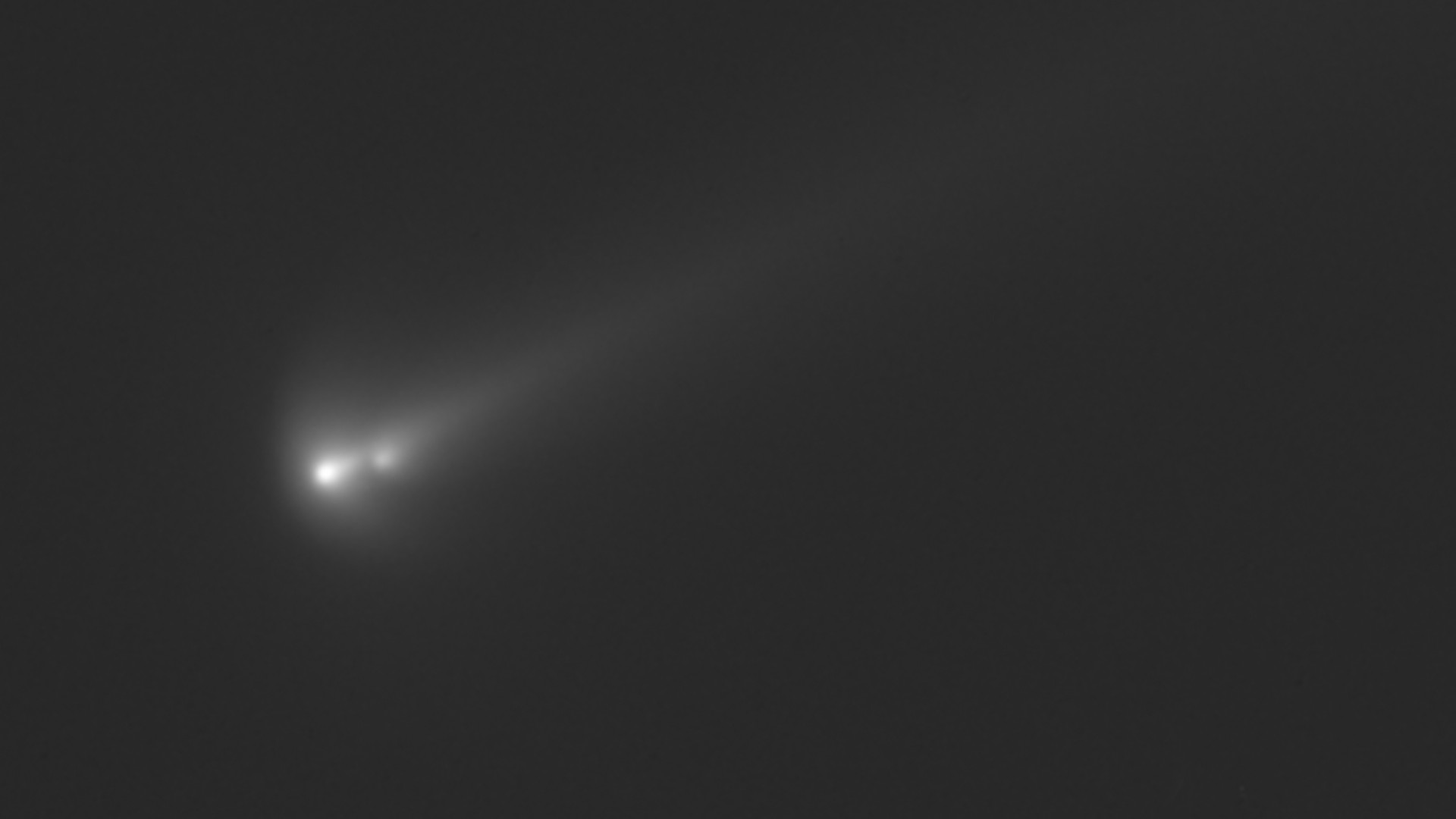 three fuzzy white dots leave a fuzzy trail on a black background