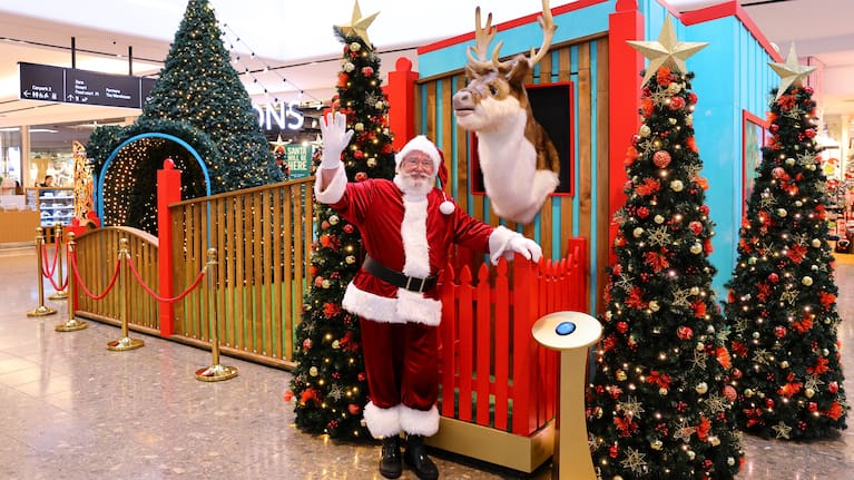 Santa Claus waves from his workshop at Auckland's Sylvia Park.