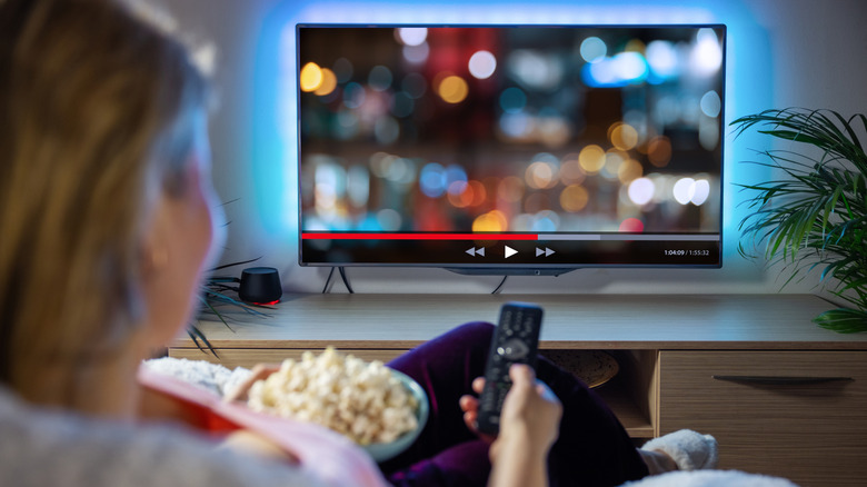 A woman streaming content on an Android TV
