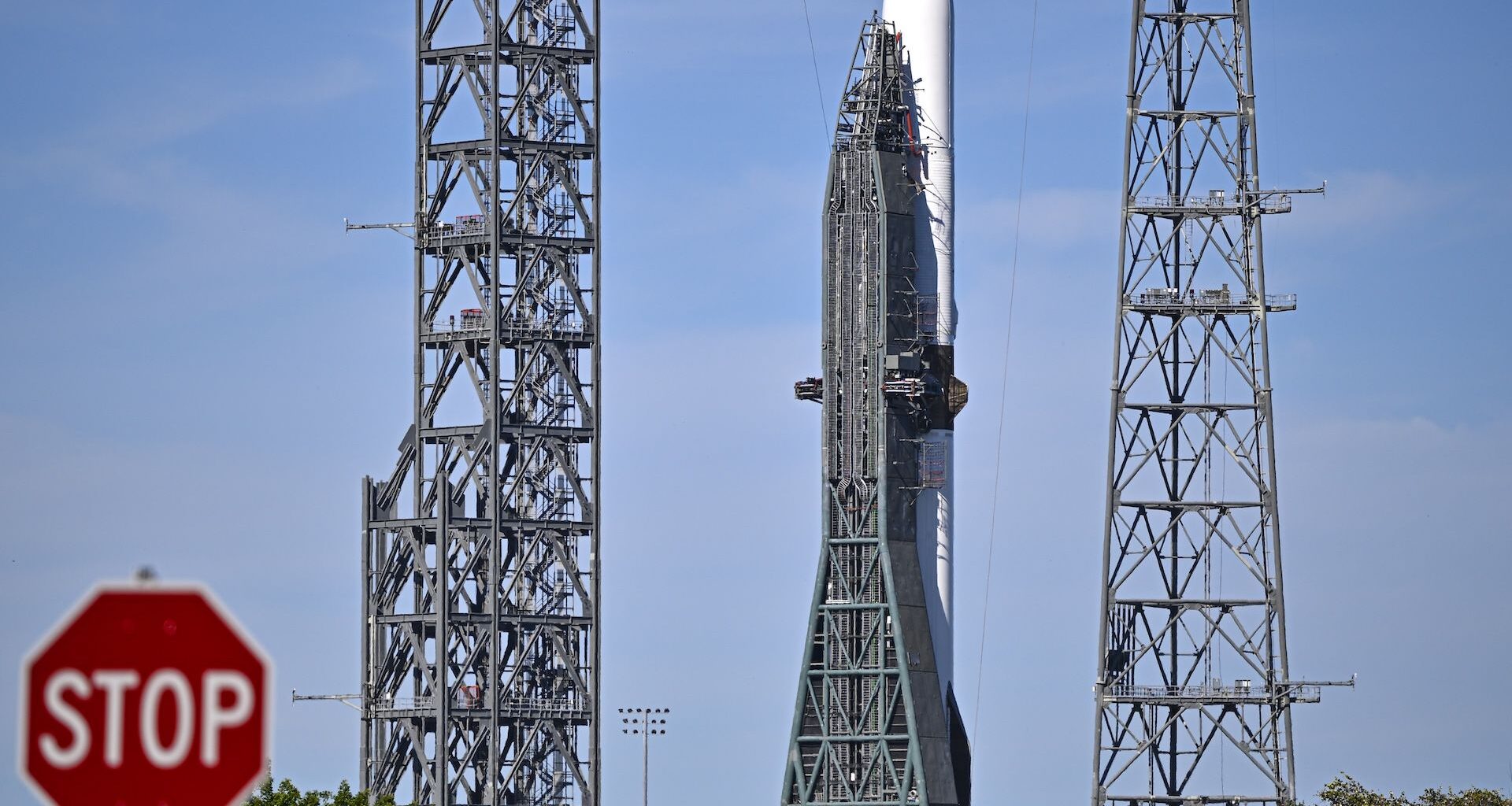 a photo of Blue Origin's New Glenn rocket with a "stop" sign visible in the foreground