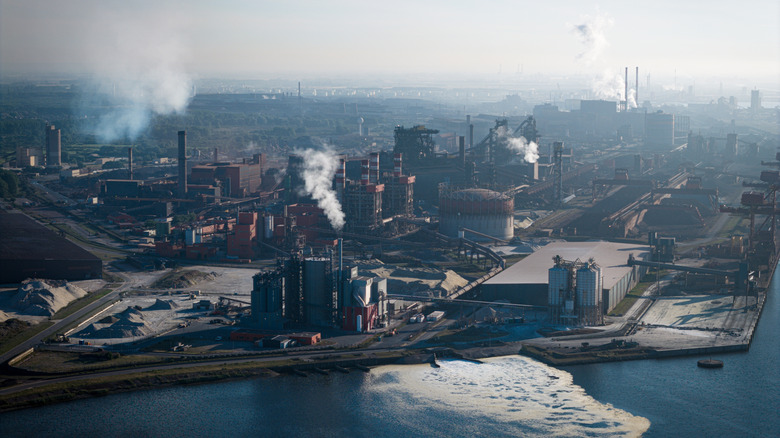 factories burning fossil fuels in a city