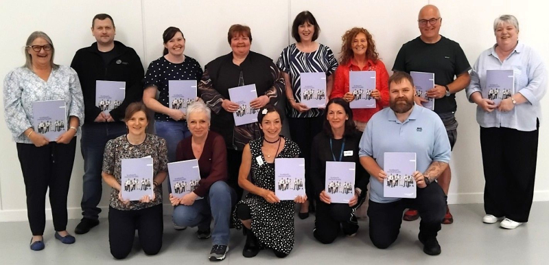 Group of people posing with training awards.