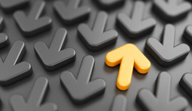 One yellow up arrow amid grey down arrows