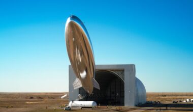 A silvery blimp shape satellite seems to float above the desert of New Mexico