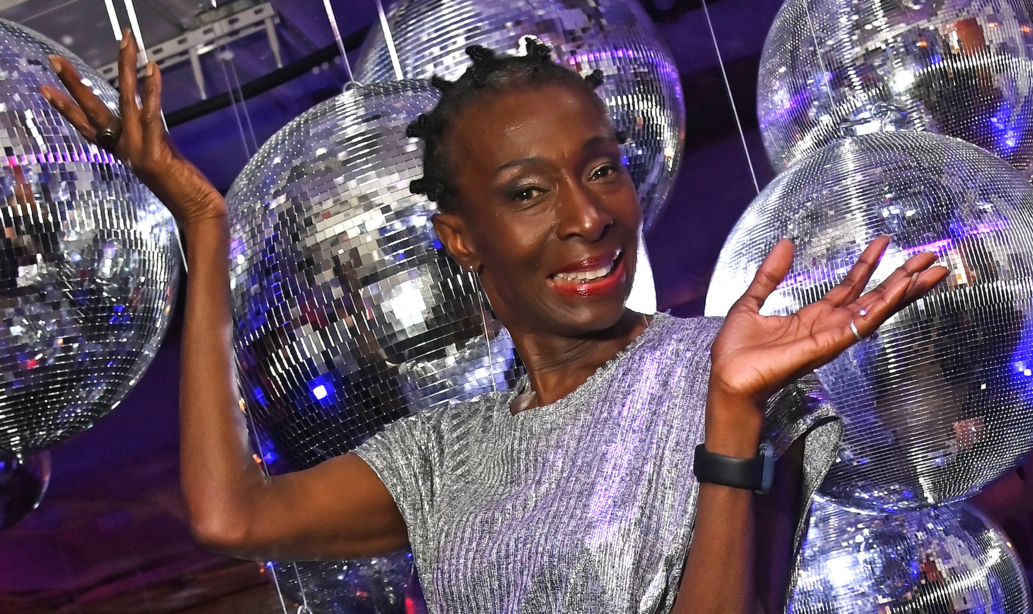 Alison Limerick smiles and poses for a photo surrounded by disco balls.
