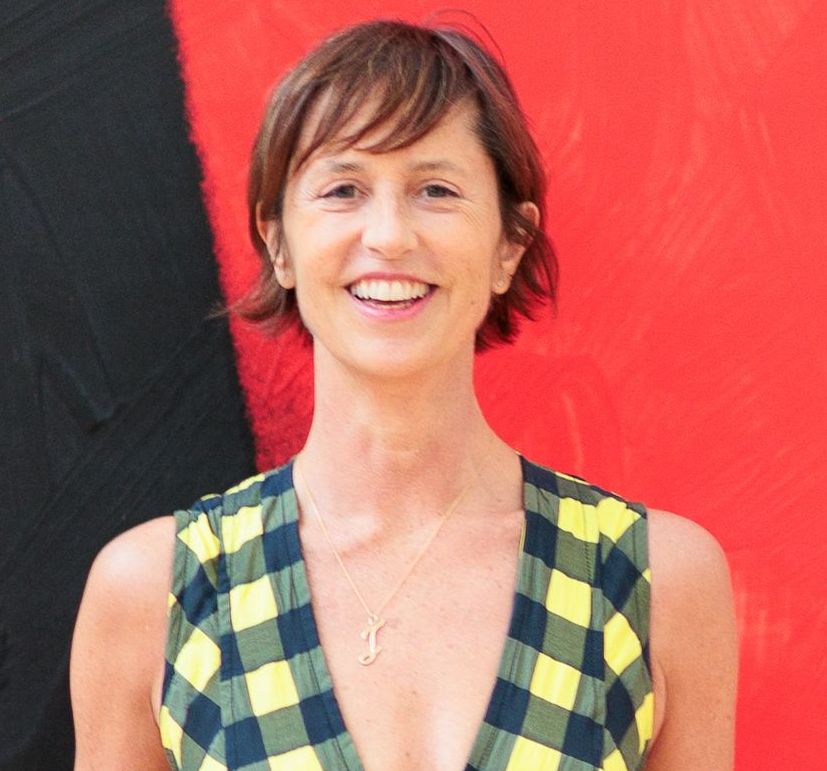 Jessica Morgan wearing a yellow and black checkered dress.