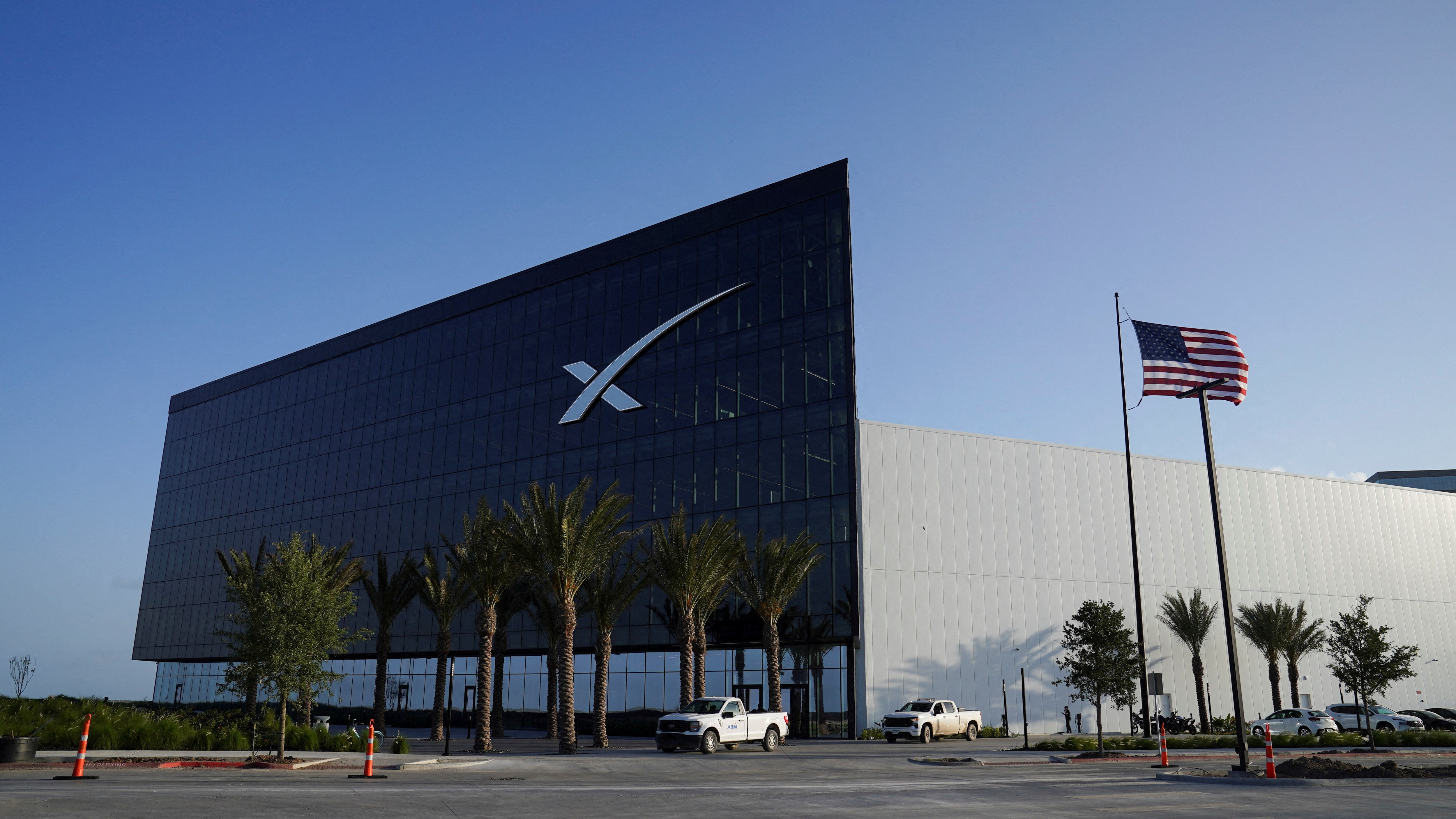 The SpaceX Starbase facility in Starbase, Texas, with an American flag flying nearby.