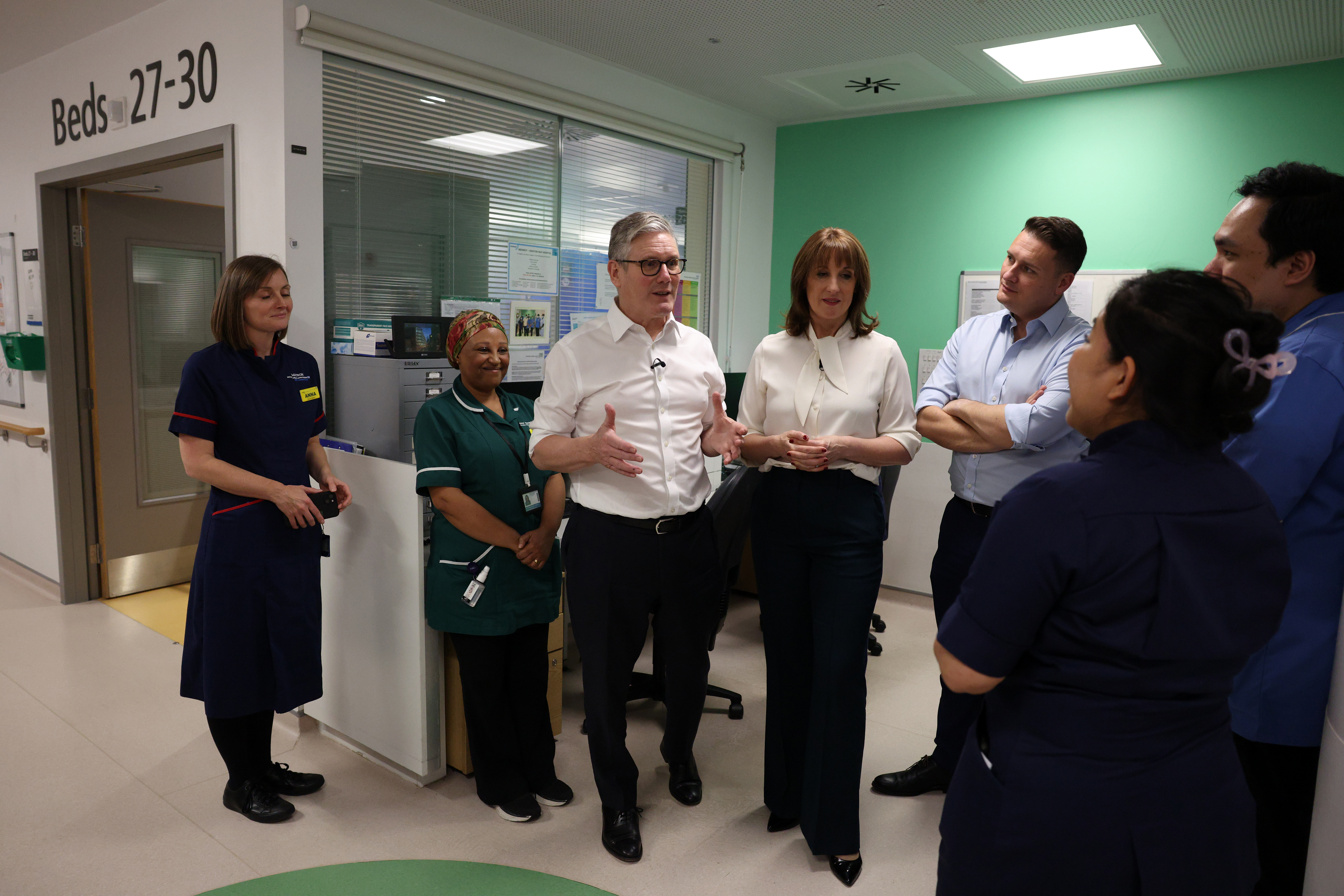 Keir Starmer, Rachel Reeves, and Wes Streeting speak with nurses and hospital staff at University College London Hospital.