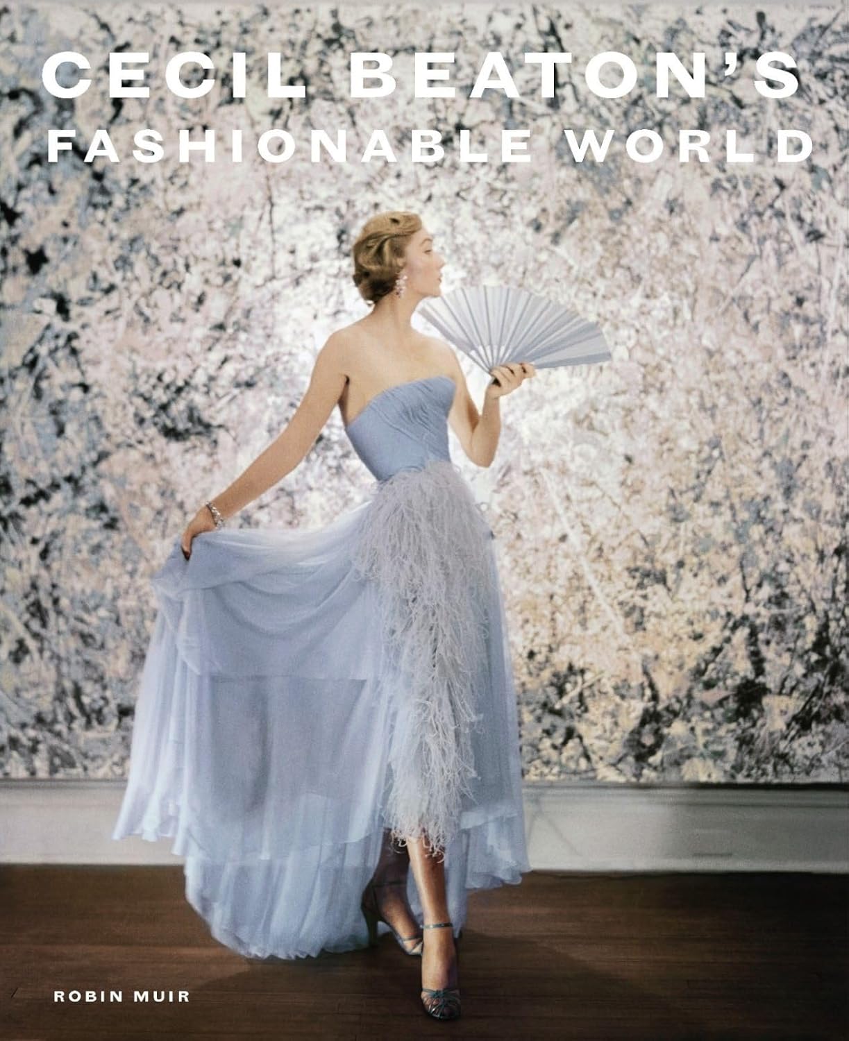 Book cover for "Cecil Beaton's Fashionable World" by Robin Muir, featuring a woman in a light blue gown holding a fan.
