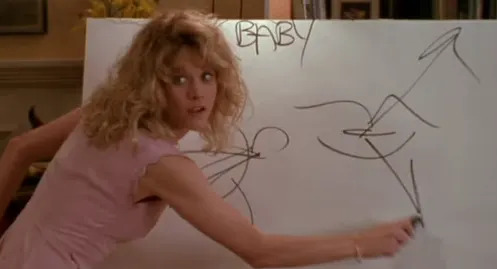 A person in a sleeveless top points at scribbles on a large whiteboard with "BABY" written on it