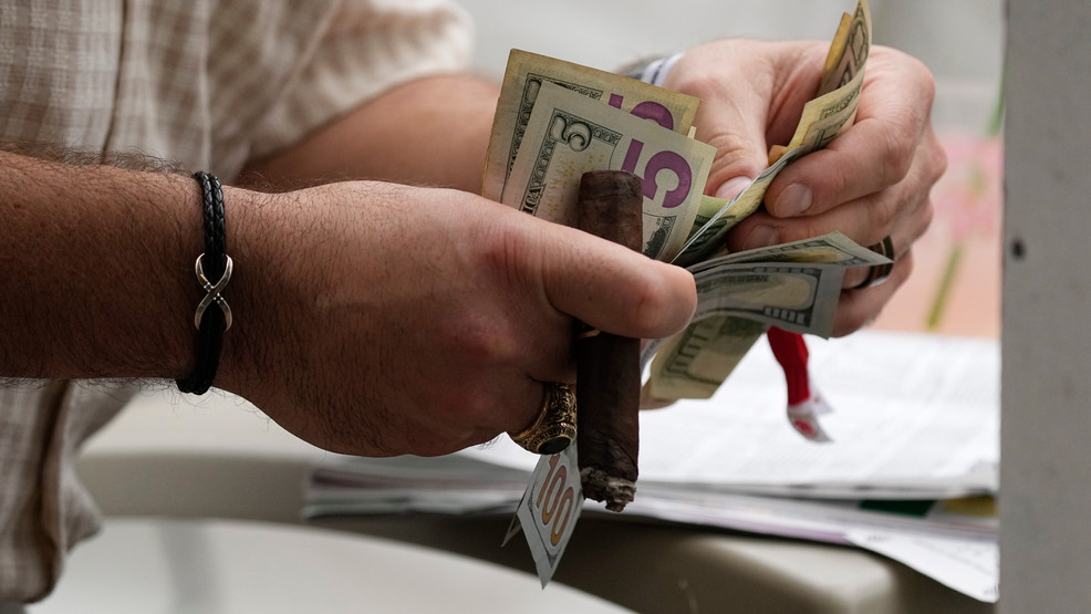FILE - A spectator places a bet before the 148th running of the Kentucky Derby horse race at Churchill Downs Saturday, May 7, 2022, in Louisville, Ky. (AP Photo/Charlie Riedel, File)