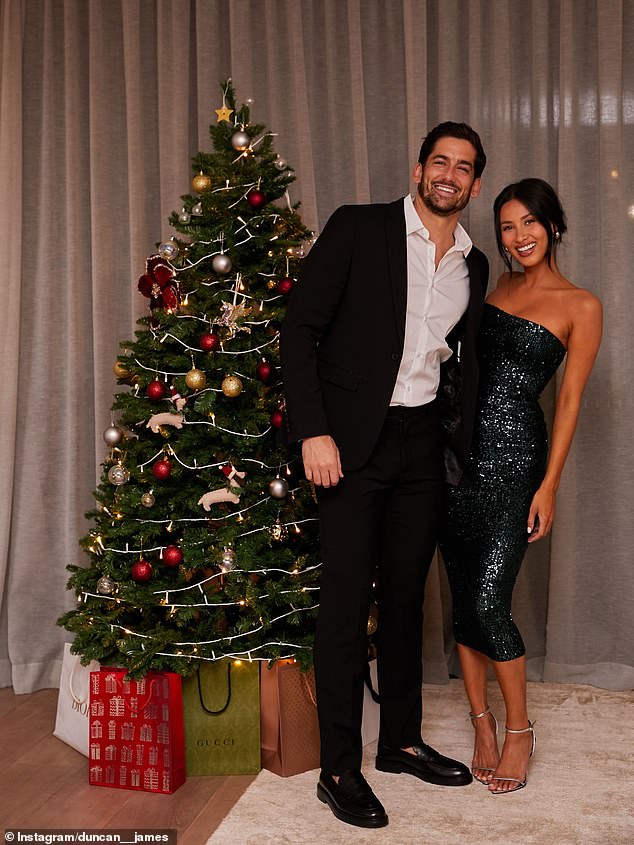 Married At First Sight's Evelyn Ellis and Duncan James turned up the sparkle with an elegant indoor Christmas portrait in front of a twinkling tree adorned with red, gold and silver baubles