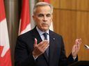 Prime Minister Mark Carney speaks during a press conference after a Cabinet meeting to discuss both trade negotiations with the U.S. and the situation in the Middle East, at the National Press Theatre in Ottawa, July 30, 2025.