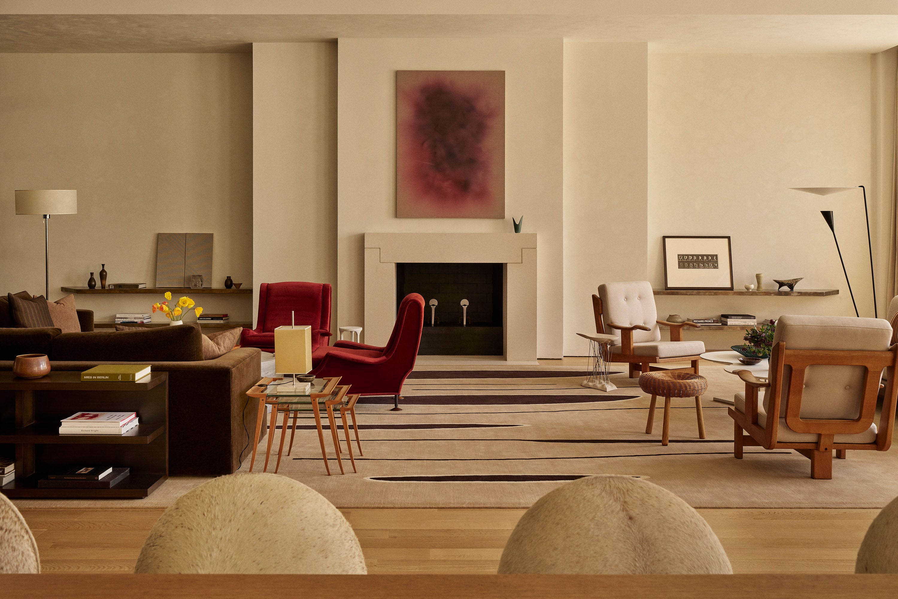 Modern living room with various seating arrangements and decor elements.