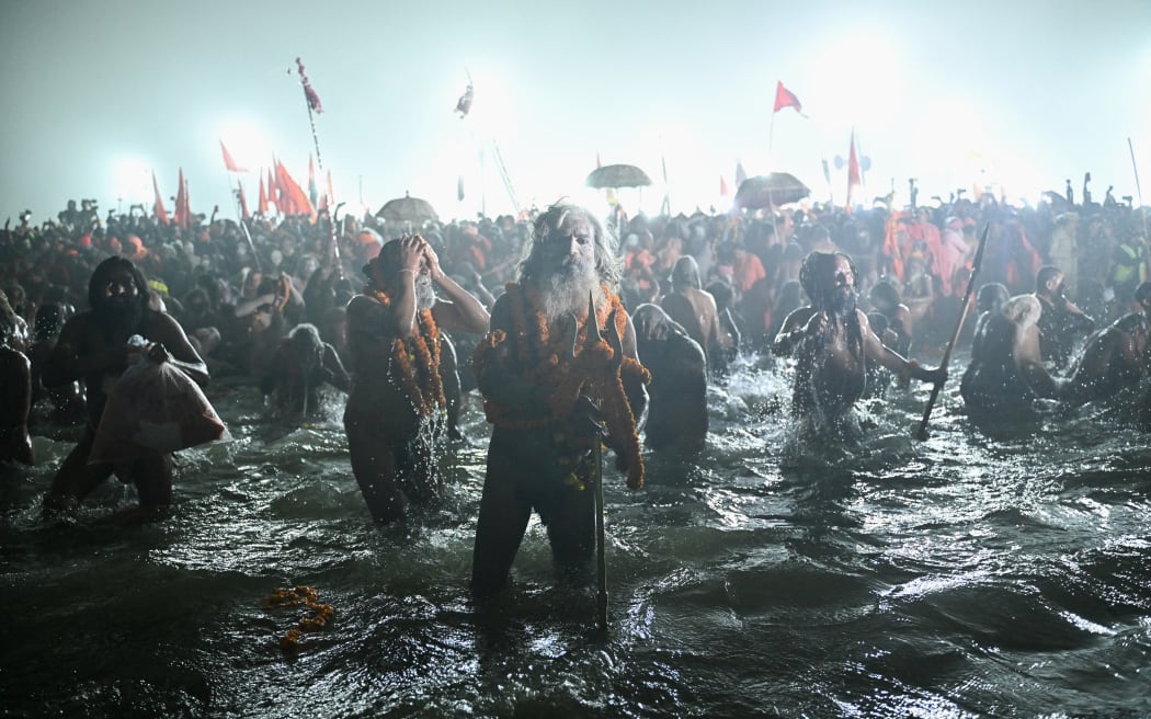Naga Sadhus or Hindu holy men take a dip in Sangam, the confluence of Ganges, Yamuna and mythical Saraswati rivers, during Shahi Snan or 'royal bath', to mark the Maha Kumbh Mela festival, in Prayagraj on January 14, 2025.
