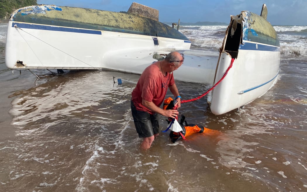 The skipper returns to salvage belongings after his boat capsized on Tuesday afternoon (30/12/25) off the coast of Sandy Bay.