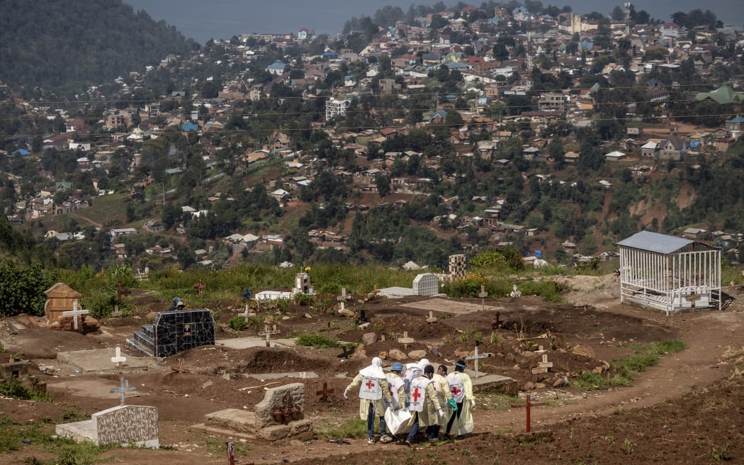 Members of the Congolese Red Cross carry body bags containing human remains during a mass burial for victims of the clashes in eastern Democratic Republic of Congo at Musigiko cemetery in Bukavu on February 20, 2025.