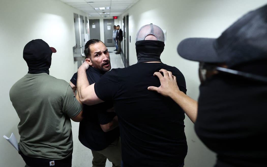 A man is detained by federal agents after his hearing at New York Federal Plaza Immigration Court inside the Jacob K. Javitz Federal Building in New York on October 1, 2025.