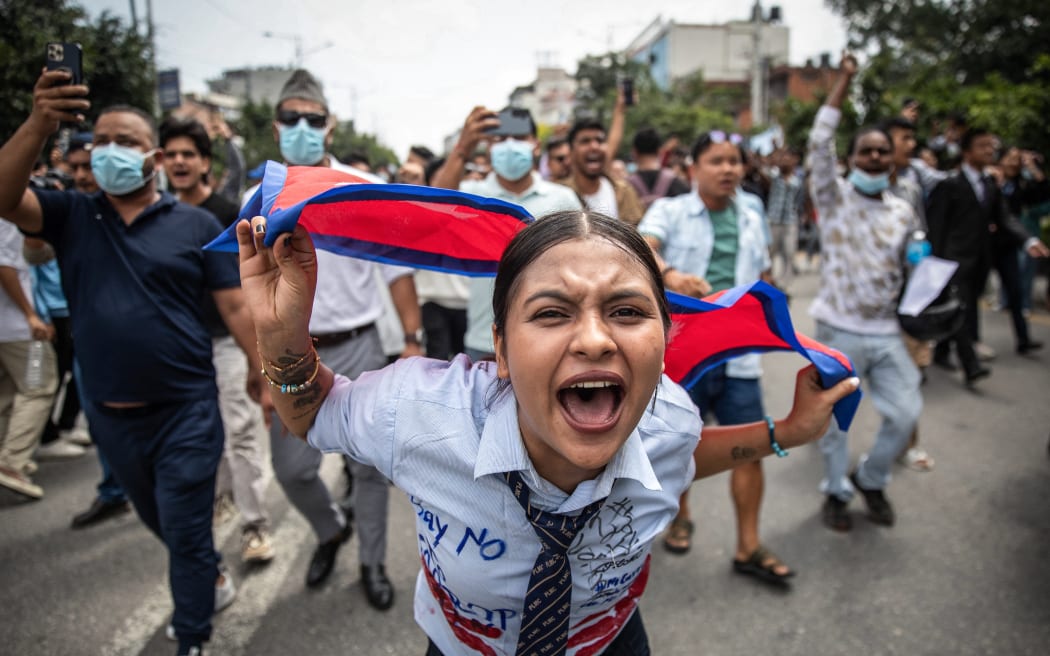 A demonstrator shouts slogans during a protest outside the Parliament in Kathmandu on September 8, 2025, condemning social media prohibitions and corruption by the government. Nepal police on September 8 opened fire, killing at least 17 people as thousands of young protesters took to the streets of Kathmandu demanding the government lift a social media ban and tackle corruption.