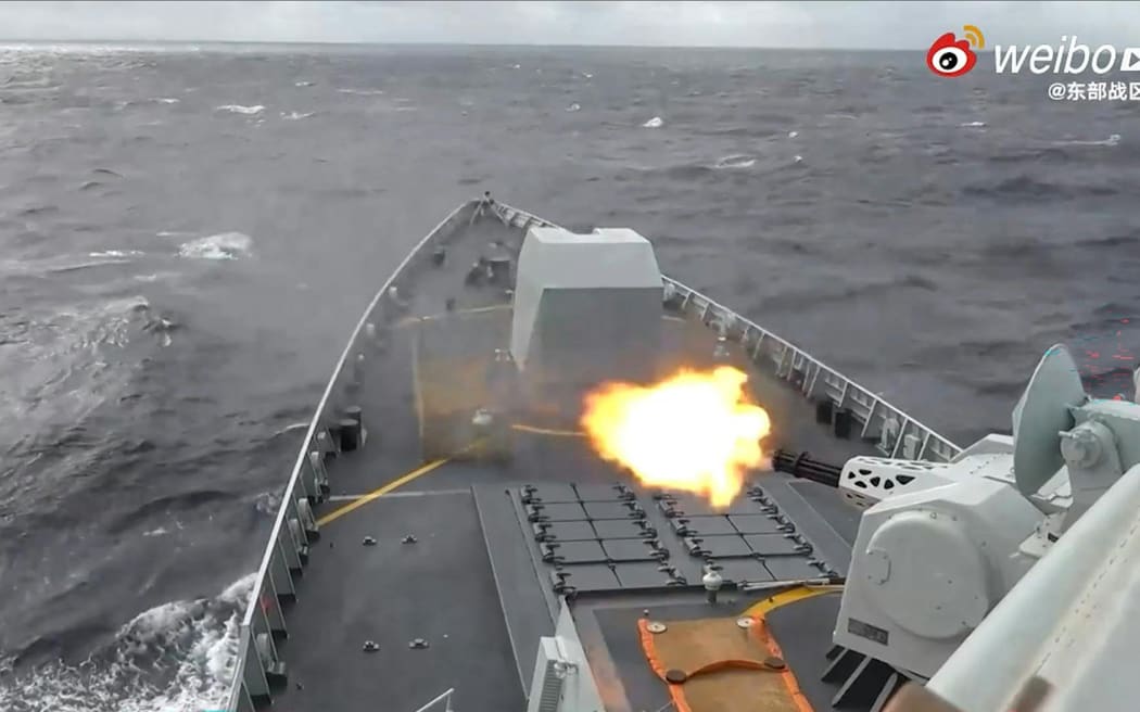 This frame grab from China's People's Liberation Army (PLA) Eastern Theater Command undated handout video footage released on December 29, 2025 via AFPTV shows a Chinese warship shooting in an undisclosed location.