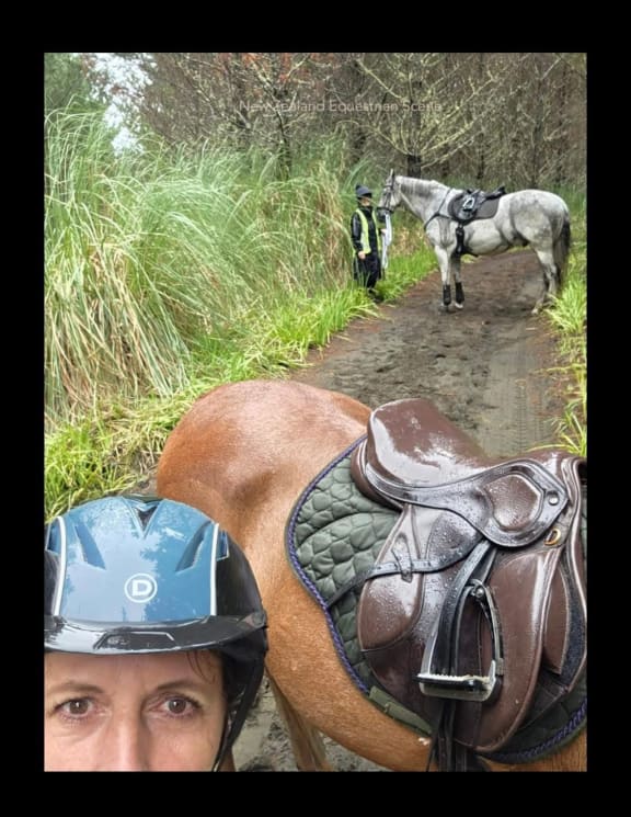 Rachel and Liz, the women who found Scooter, leading him out.
