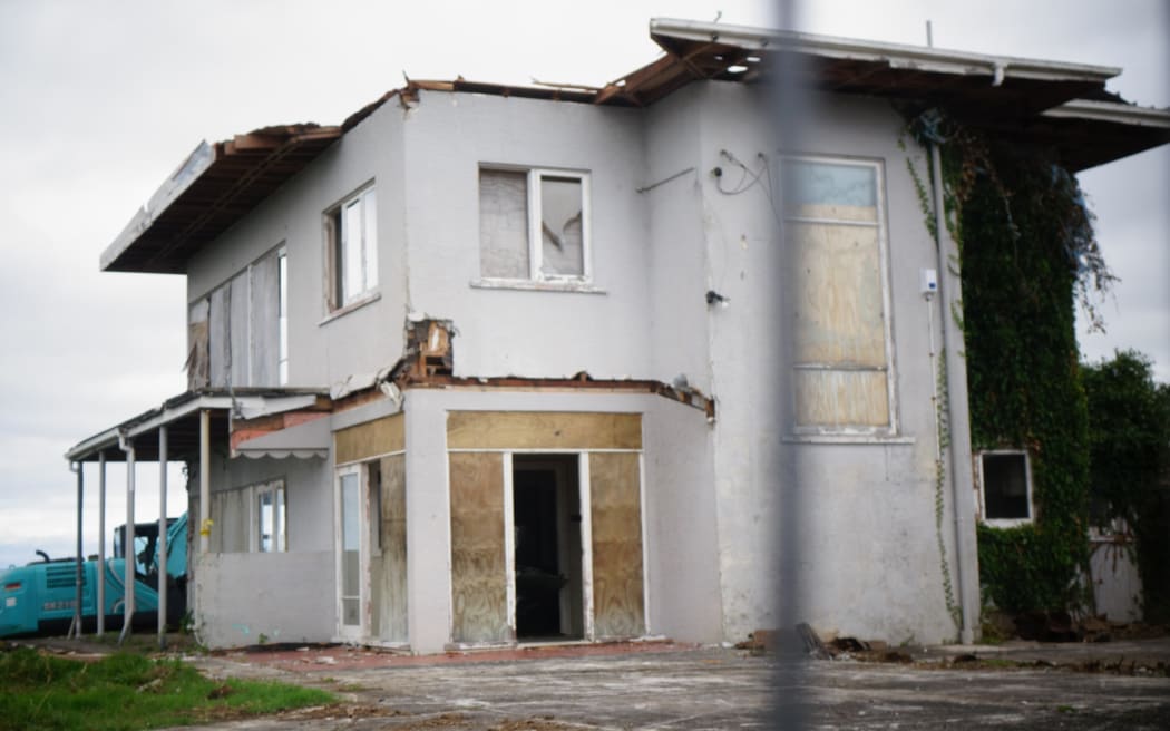 The roof of an unoccupied home in the Auckland suburb of Hillsborough came off in high winds and scattered debris down the road.