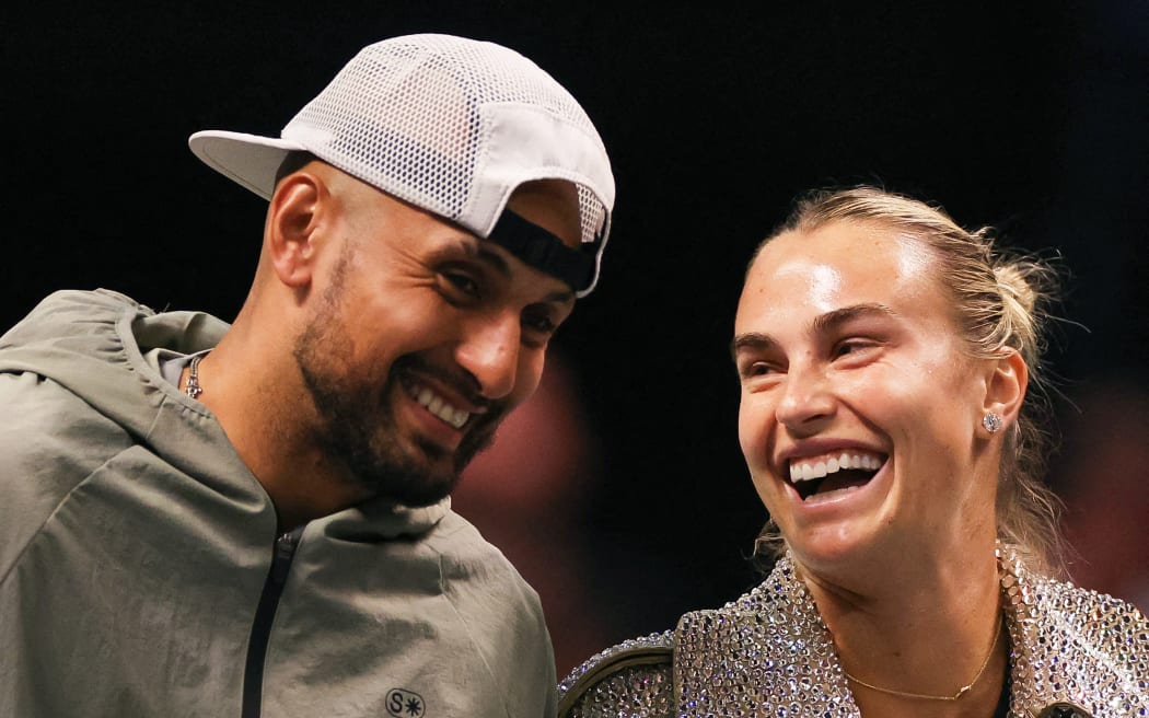 Australia's Nick Kyrgios (L) and Belarus’ Aryna Sabalenka share a laugh prior to their Battle of the Sexes exhibition tennis match in Dubai, 2025.