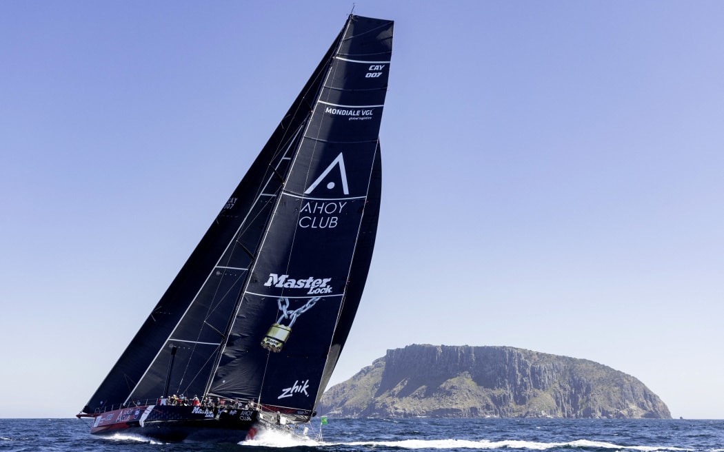 This handout image taken and received from Rolex on December 28, 2025 shows Master Lock Comanche sailing near Tasman Island, during the annual Sydney to Hobart yacht race in Tasmania, Australia.