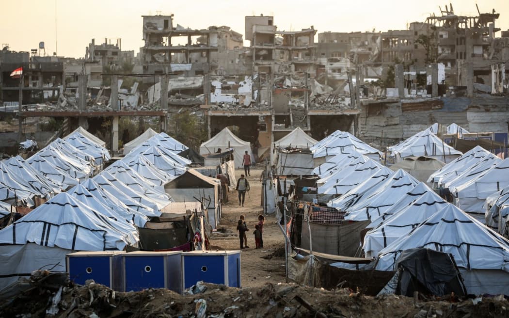 Young Palestinian girls play in a new displacement camp set up by the Egyptian Committee in Nuseirat, Gaza Strip on 11 November 2025.