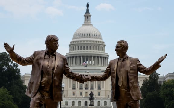 Statues depict U.S. President Donald Trump and sex abuser Jeffrey Epstein holding hands and dancing in front of the Capitol, in Washington, D.C., U.S., on September 23, 2025.  The statue is the latest to mysteriously appear in the same location, and the second to reference Trump’s ties to Epstein.  Many Americans believe that Trump has refused to release the Justice Department’s files on Epstein for self-protection. (Photo by Allison Bailey/NurPhoto) (Photo by Allison Bailey / NurPhoto via AFP)