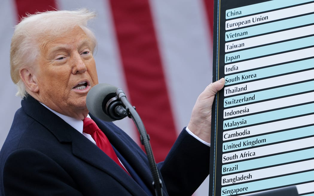 WASHINGTON, DC - APRIL 02: U.S. President Donald Trump holds up a chart while speaking during a “Make America Wealthy Again” trade announcement event in the Rose Garden at the White House on April 2, 2025 in Washington, DC. Touting the event as “Liberation Day”, Trump is expected to announce additional tariffs targeting goods imported to the U.S.   Chip Somodevilla/Getty Images/AFP (Photo by CHIP SOMODEVILLA / GETTY IMAGES NORTH AMERICA / Getty Images via AFP)