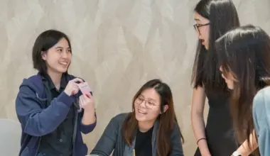 At a workshop organised by UOB in July, Ms Sarah Chee (second from left) learnt financial concepts, such as the importance of insurance and building passive income, through a board game.