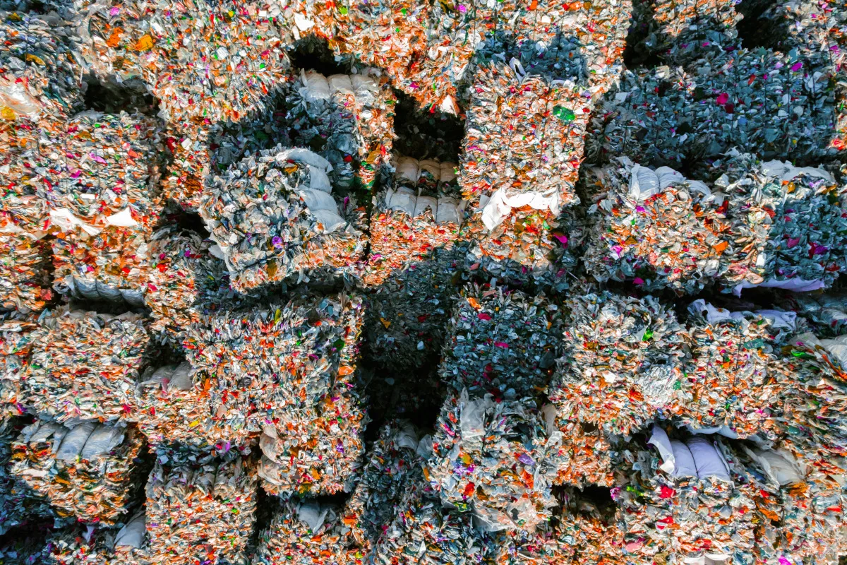 Directly above view of a piles of crushed plastic bales stacking in a recycling plant