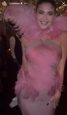 Kylie Jenner/Instagram Kylie Jenner in a feathered gown at the Kylie Cosmetics holiday party