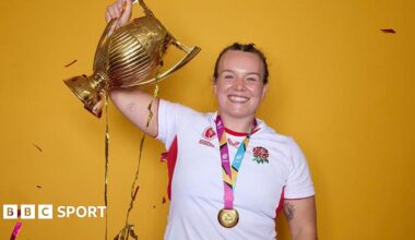 Lark Atkin-Davies holding the Rugby World Cup trophy