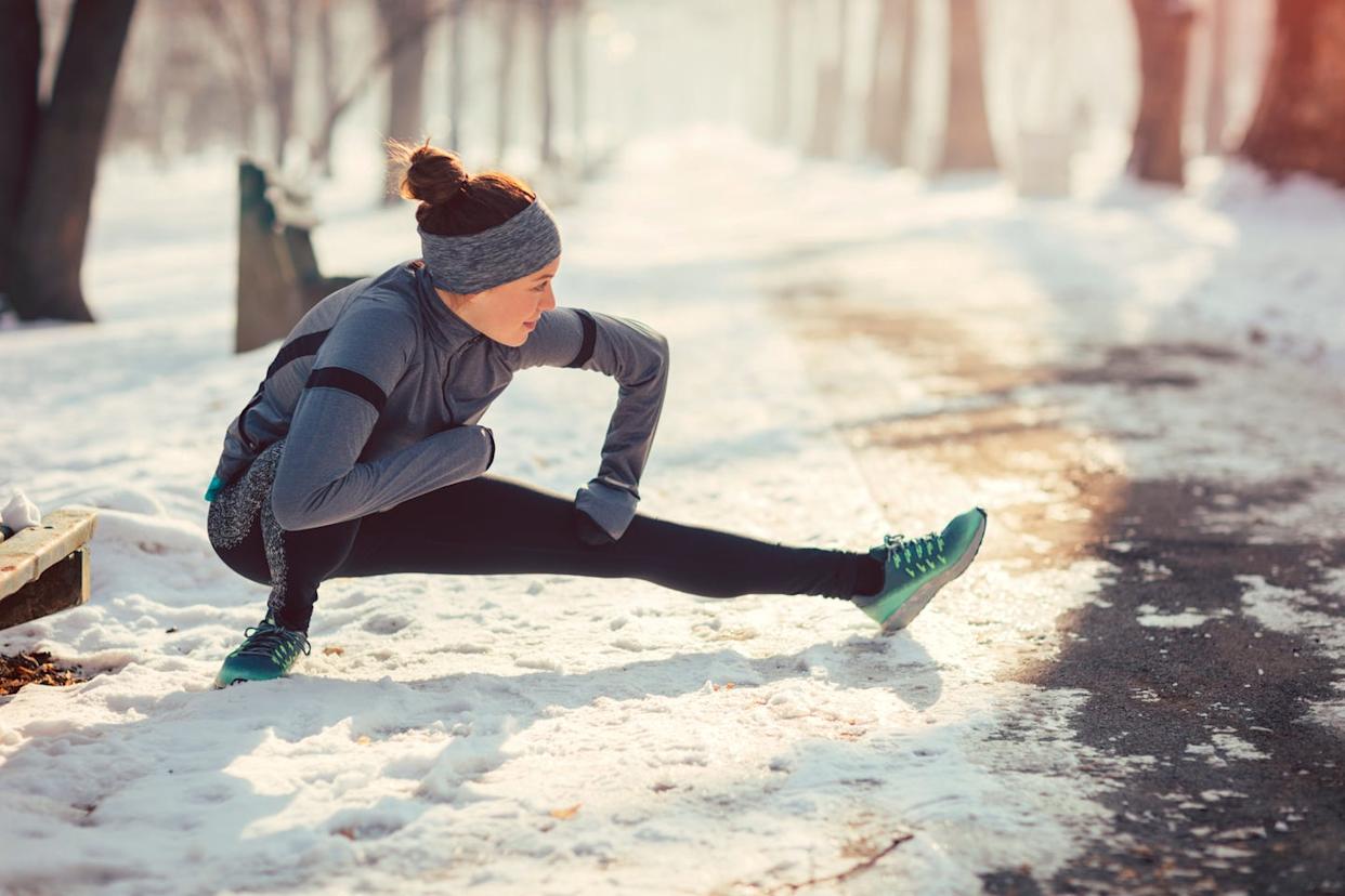 woman stretching outdoors in the snow