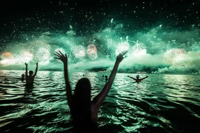 People react to the fireworks on the new year's celebration at Copacabana beach in Rio de Janeiro, Brazil, on 1 January 2014.