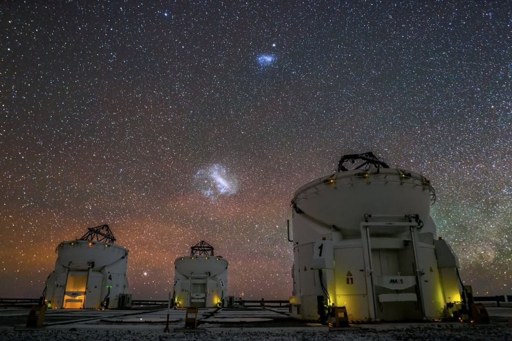 The Large and Small Magellanic clouds in the night sky over the Very Large Telescope's auxiliary telescopes in Paranal, Chile. A new research group focused on the clouds will begin operations at the Leibniz Institute for Astrophysics Potsdam (AIP) in 2026. It will focus on the satellite galaxies' formation and evolution. Image Credit: J. C. Muñoz/European Southern Observatory