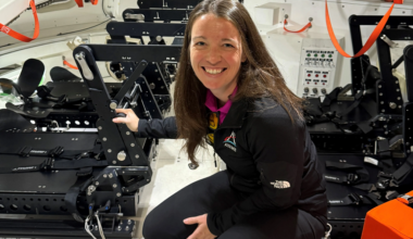 Branelle Rodriguez crouches inside training version of Orion spacecraft