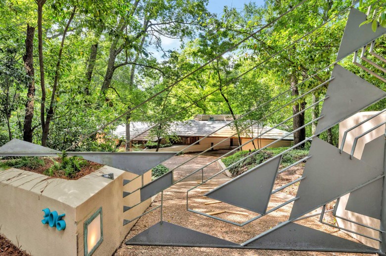 A view of the Fountainhead home from the street, with a geometric fence