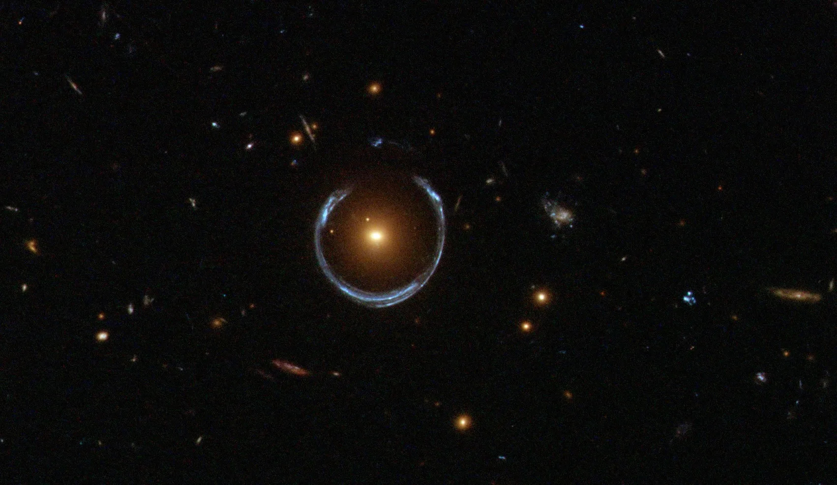 A horseshoe shaped glowing light in the darkness of deep space