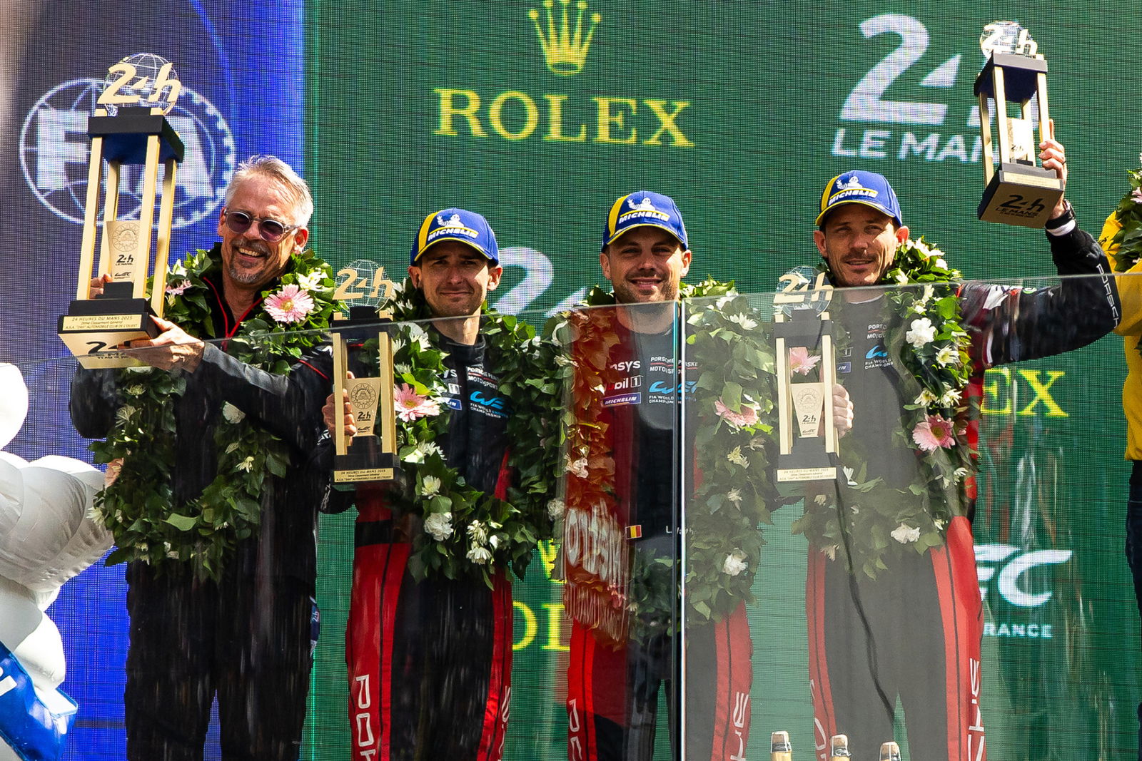 Matt Campbell (second from left) on the 24 Hours of Le Mans podium with his Porsche Penske Motorsport teammates.