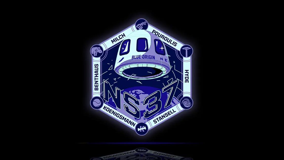 a hexagonal mission patch featuring a white space capsule against a dark-blue background