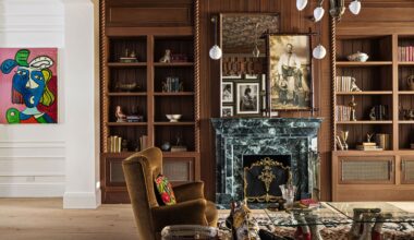 NYC parlor room featuring warm woods, a green marble fireplace, and contemporary artwork