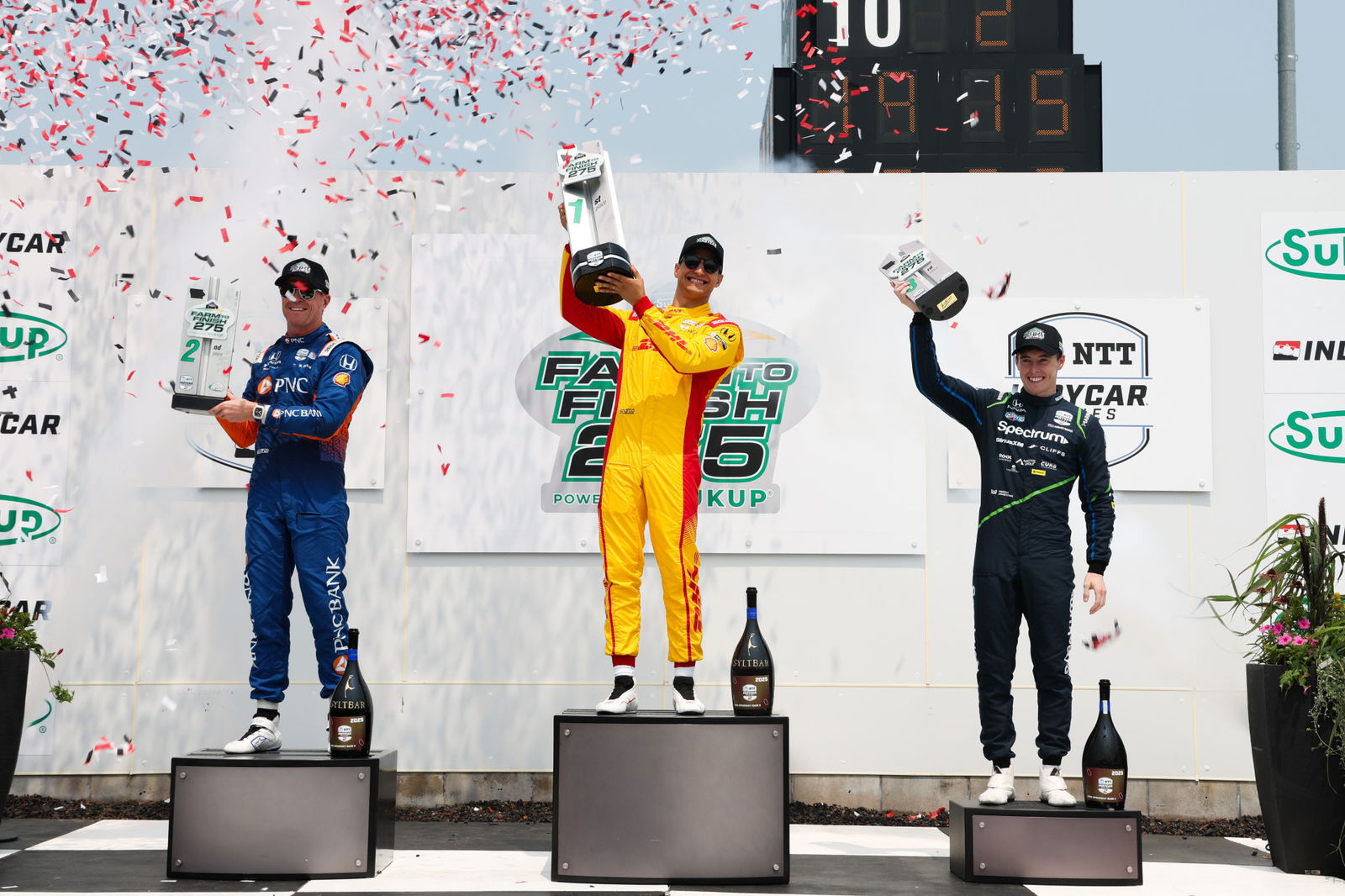 Marcus Armstrong (right) on the podium with winner Alex Palou and Scott Dixon. 