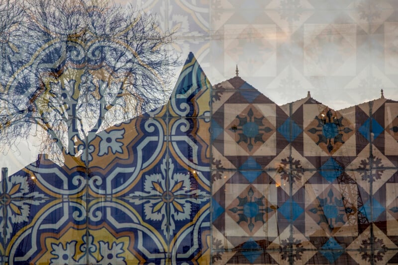A layered image showing blue and yellow decorative tiles, a bare tree, and the pointed roofs of buildings, blending architecture, nature, and geometric patterns in a single composition.