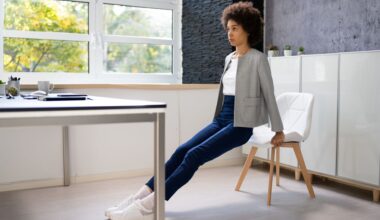 woman in work attire does tricep dips at her desk