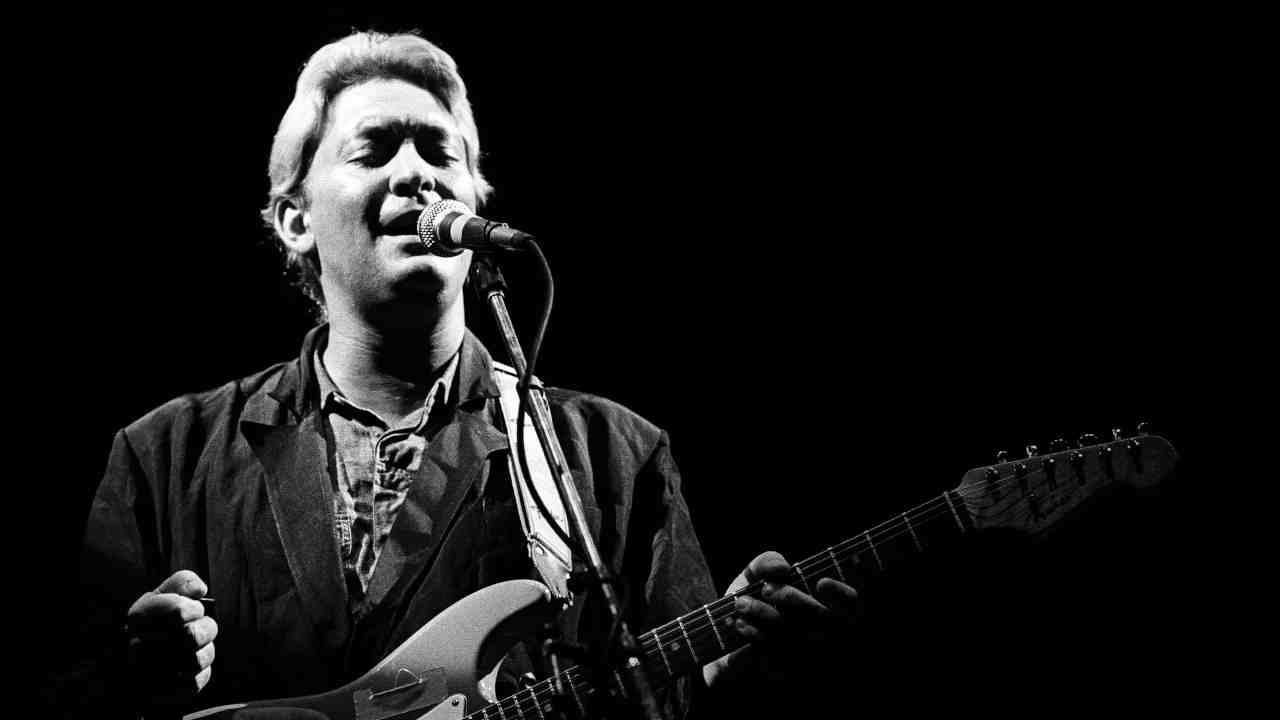 Chris Rea performing onstage in 1985